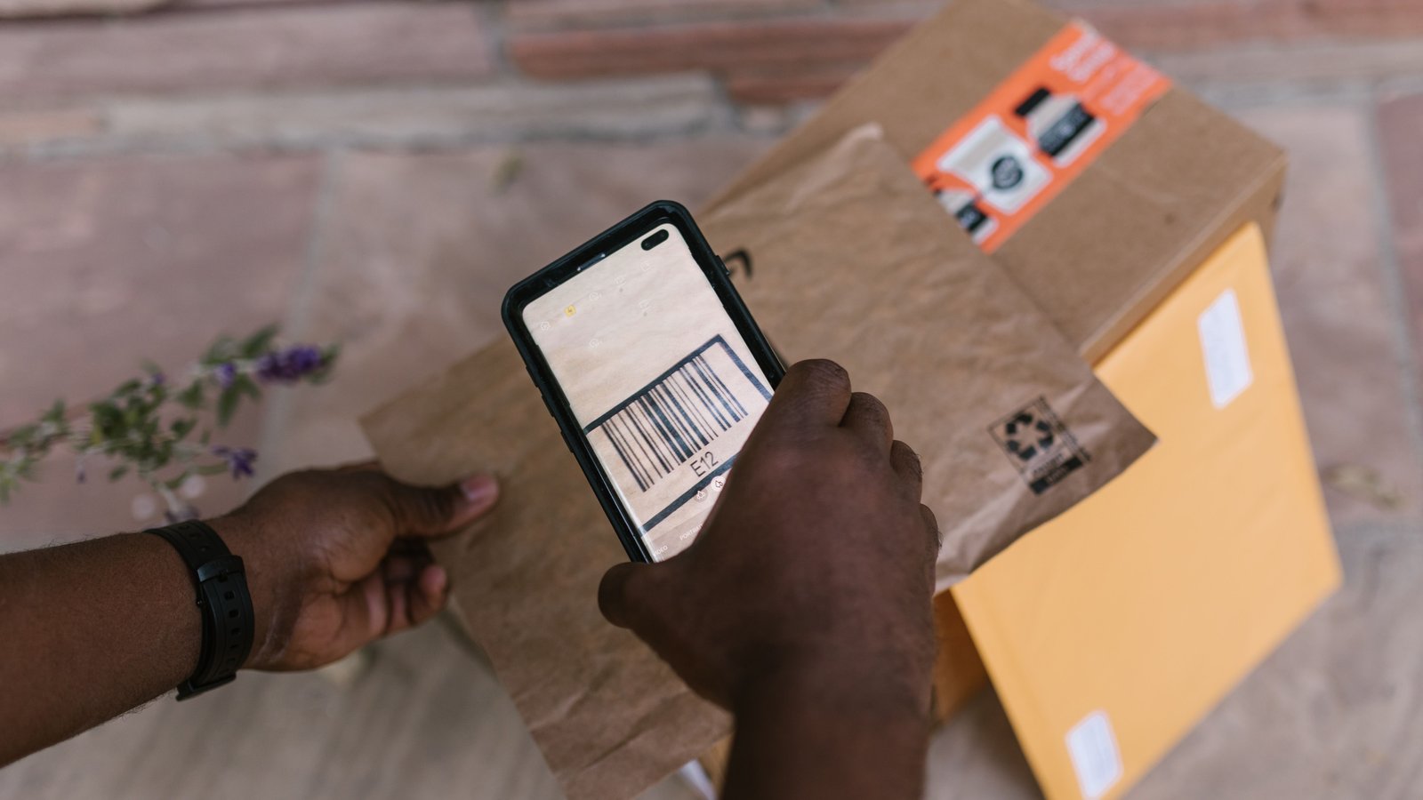 A packer scanning an item at a packing station